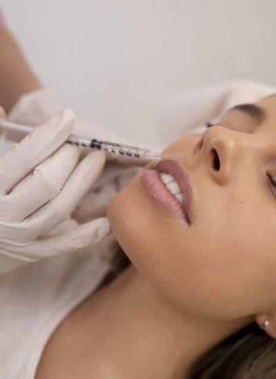 close-up-woman-getting-lip-filler-with-injection